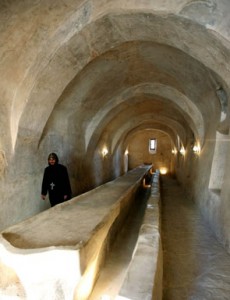 A monk walks down renovated monks' quarters at St. Antony's Monastery
