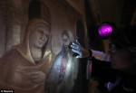 Restorer examines Giotto painting with UV lights