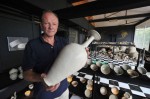 Heymans holding Liao Dynasty vase, other Imperial porcelain in the background