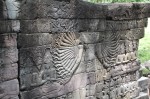 Bas-relief of a 32-armed Avalokiteshvara on west side of Banteay Chhmar; looters took the wall from the gap on the right onward