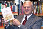 Hartmut Hegeler holding one of his 17 books on Germany's witch trials