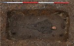 Grave composite; iron brackets from the bed frame surround the skeleton