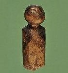 Carved wooden doll with charred face