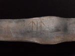 Runes inscribed on silver ingot. Photo courtesy National Museums Scotland.