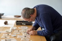 Frank Giecco examines some of the artifacts found. Photo by Stuart Walker, The Cumberland News.