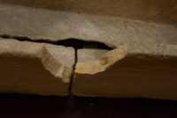 Crack running down the side and base of the coffin. The new damage is the chunk missing from the bottom of the coffin. The missing piece on the edge is pre-existing damage. Photo courtesy Prittlewell Priory Museum.