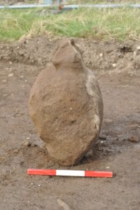 Carved stone recovered before cleaning. Photo courtesy ORCA Archaeology.