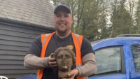 Craig Crawley with the head of the sculpture. 
