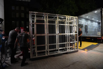 Workers unload the crate containing the tapestry at the British Museum. (AP Photo/Kwiyeon Ha)