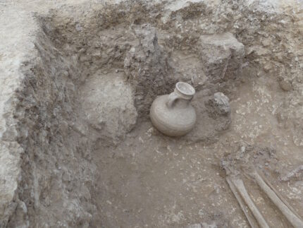 Local pottery at the feet of the deceased. Photo courtesy Elsa Chiron, INRAP.